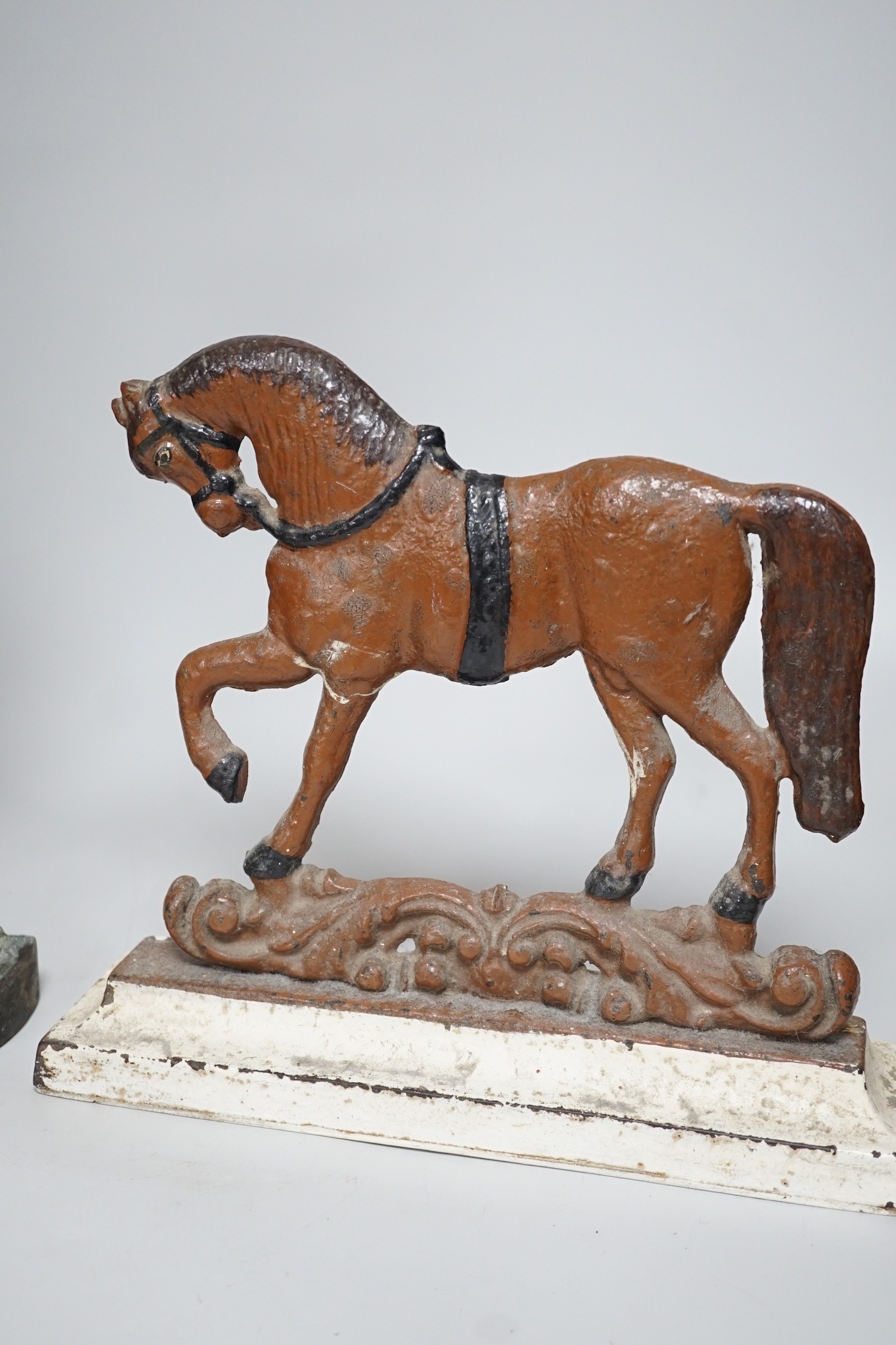 A Victorian bronze cherubic door stop, 45cm, and another painted equine door stop